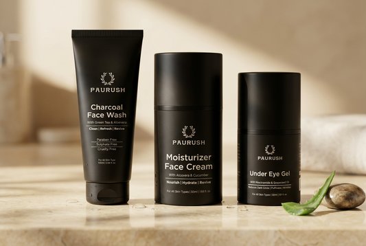 PAURUSH Charcoal Face Wash, Moisturizer Face Cream and Under Eye Gel together on a sunlit stone countertop with aloe.